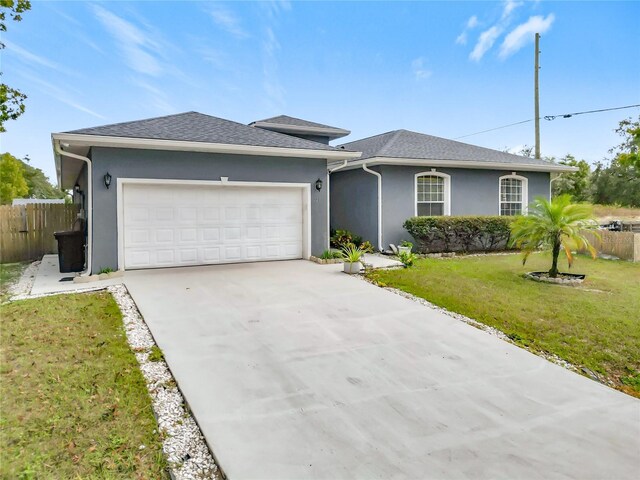 227 Locust Pass Crse, Ocala, FL 34472 - view of front facade featuring stucco siding, concrete driveway, and a garage