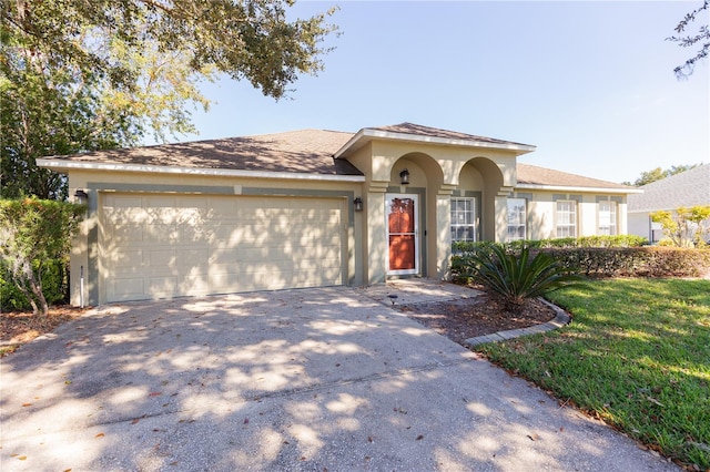 view of front of house with a garage and a front yard