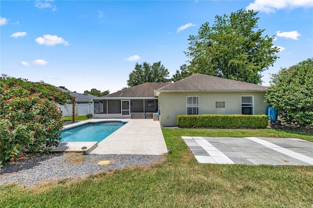 view of swimming pool with a sunroom and a yard