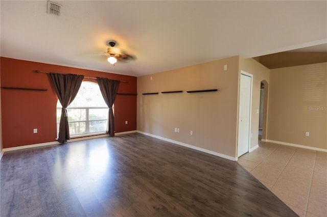 spare room with hardwood / wood-style floors and ceiling fan