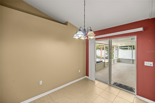 carpeted empty room featuring a chandelier and vaulted ceiling