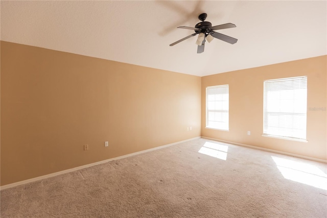 carpeted spare room with ceiling fan