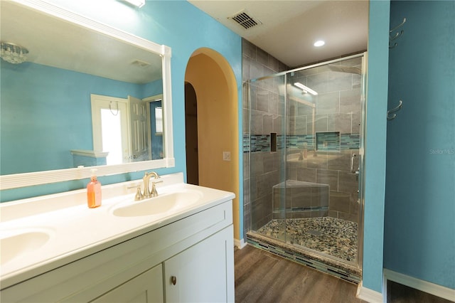 bathroom with vanity, an enclosed shower, and hardwood / wood-style floors