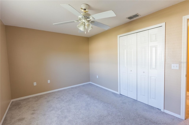 unfurnished bedroom featuring a closet, ceiling fan, and carpet floors