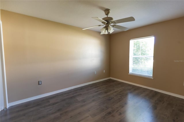 empty room featuring dark hardwood / wood-style flooring and ceiling fan