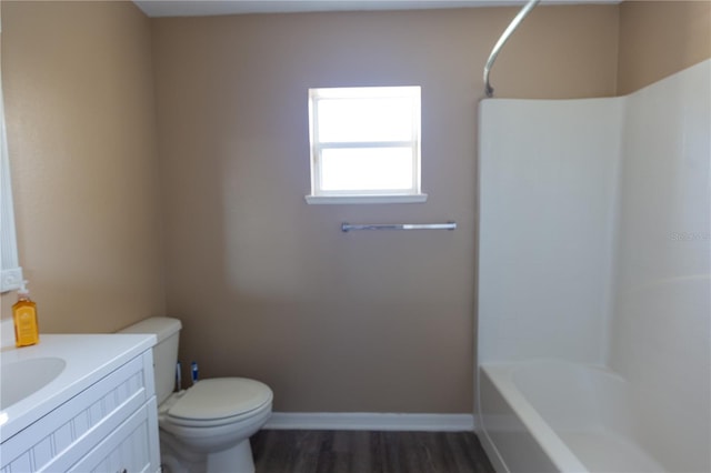 full bathroom featuring hardwood / wood-style flooring, vanity, toilet, and tub / shower combination