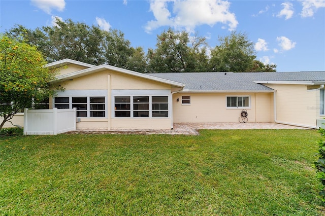 back of house with a sunroom, a yard, and a patio area