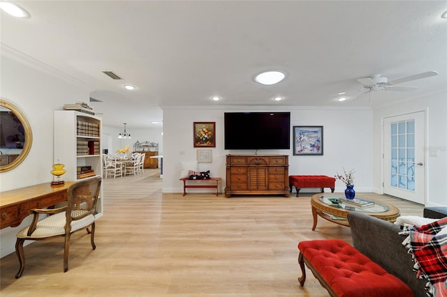 living room featuring ceiling fan, light hardwood / wood-style flooring, and ornamental molding