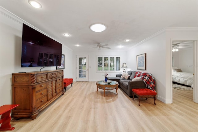 living room with light wood-type flooring, ceiling fan, and crown molding