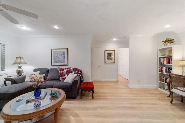 living room with ceiling fan, ornamental molding, and light hardwood / wood-style flooring