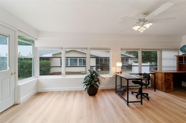 home office with light hardwood / wood-style floors and ceiling fan