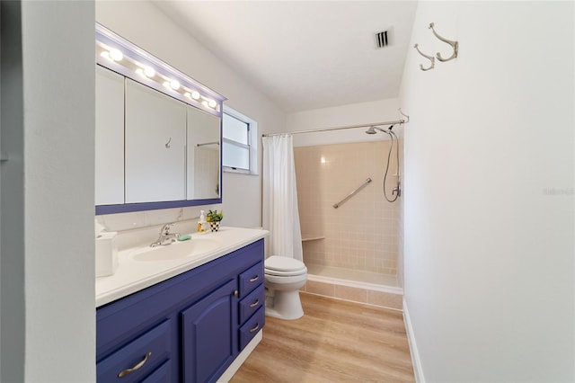 bathroom featuring a shower with curtain, wood-type flooring, vanity, and toilet