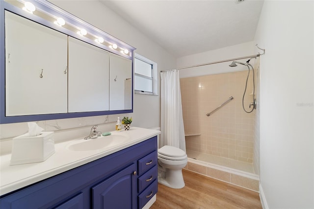 bathroom featuring a shower with shower curtain, wood-type flooring, vanity, and toilet