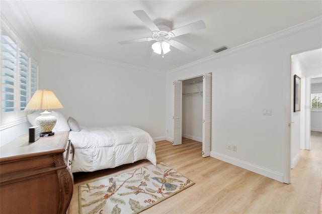 bedroom with ceiling fan, a closet, light hardwood / wood-style flooring, and ornamental molding