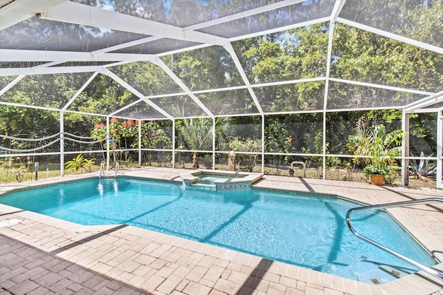 view of swimming pool with a patio, a lanai, and an in ground hot tub