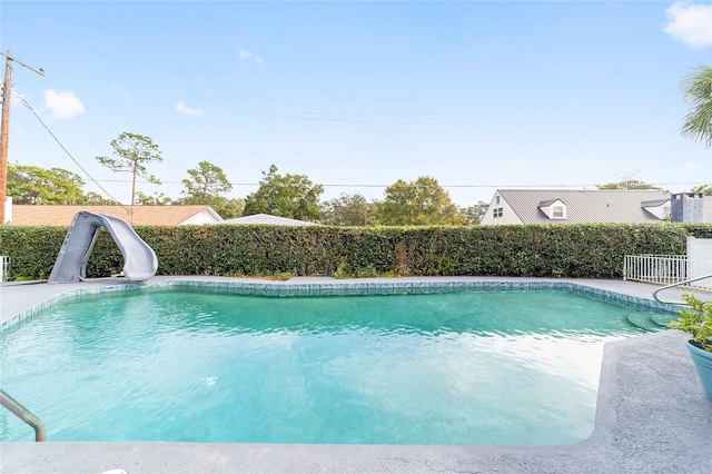 view of swimming pool with a water slide