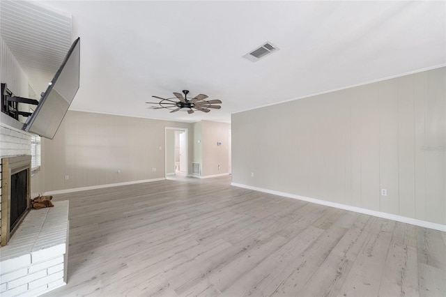 unfurnished living room featuring ceiling fan, light hardwood / wood-style floors, and a fireplace