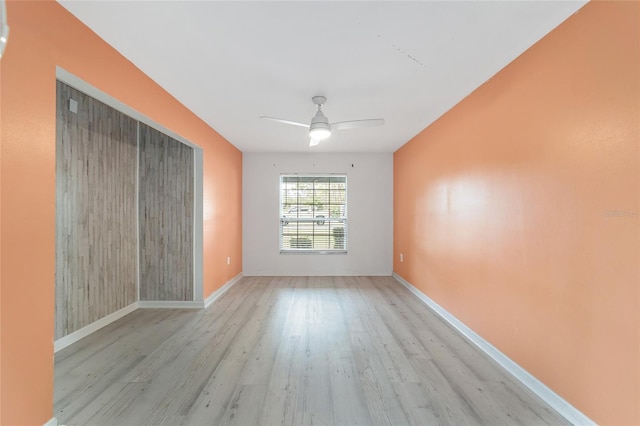 spare room featuring light hardwood / wood-style floors and ceiling fan