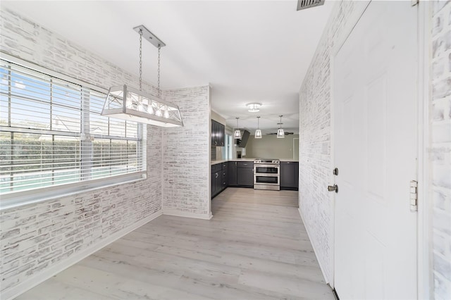 interior space featuring light hardwood / wood-style flooring and brick wall