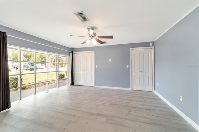 empty room featuring ceiling fan and light hardwood / wood-style floors