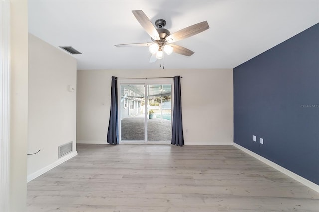 empty room with ceiling fan and light wood-type flooring