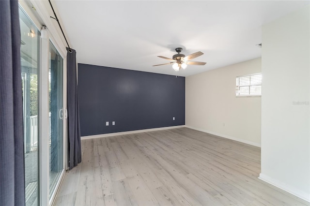 spare room featuring light hardwood / wood-style flooring and ceiling fan