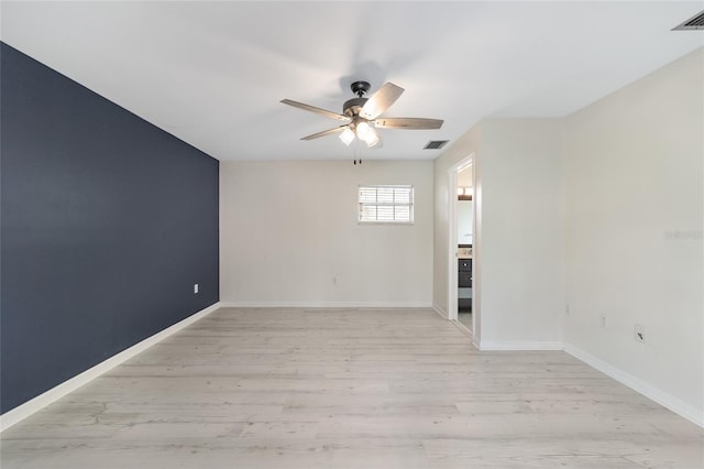 empty room with light wood-type flooring and ceiling fan