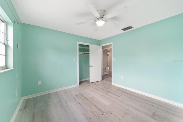 unfurnished bedroom with a closet, ceiling fan, and light hardwood / wood-style flooring