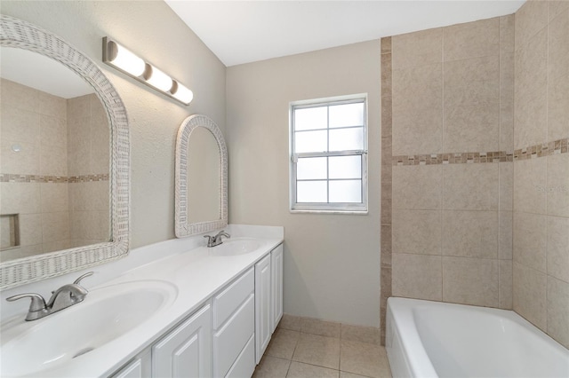 bathroom featuring a bathing tub, tile patterned flooring, and vanity