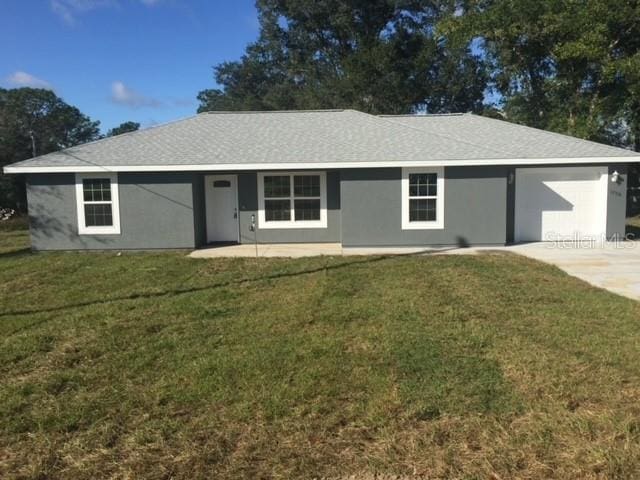 single story home with a garage and a front lawn