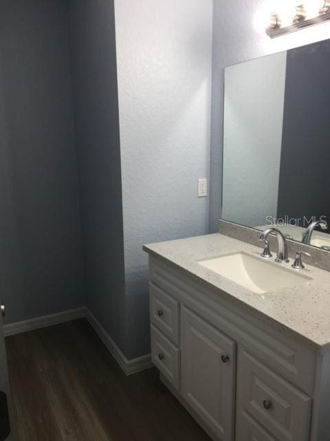 bathroom with vanity and hardwood / wood-style flooring