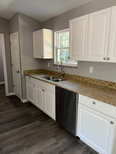 kitchen with black dishwasher, white cabinets, sink, and dark hardwood / wood-style floors