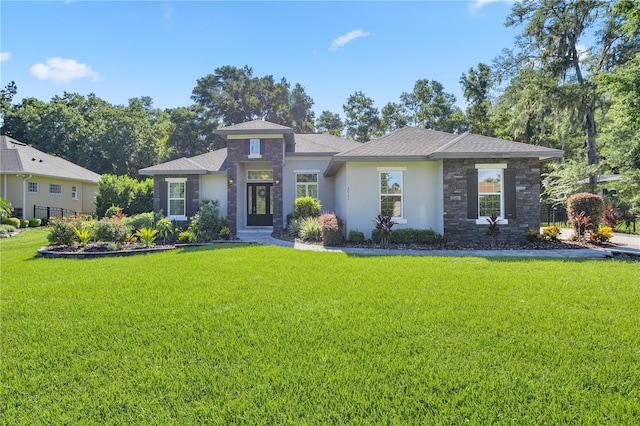 prairie-style house featuring a front lawn