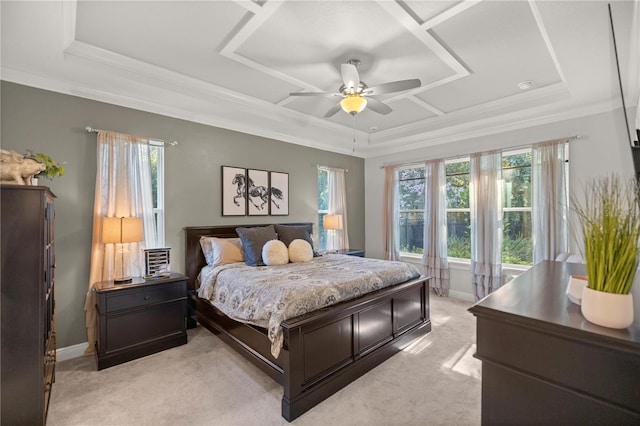 carpeted bedroom featuring a tray ceiling, ceiling fan, and crown molding