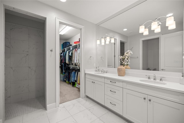 bathroom with vanity and a tile shower