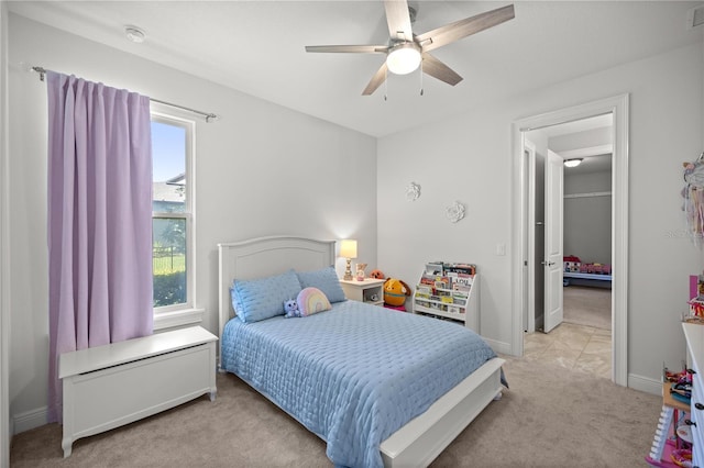 bedroom with ceiling fan and light colored carpet