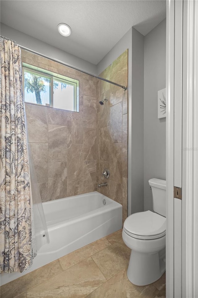 bathroom with shower / bath combination with curtain, toilet, and a textured ceiling