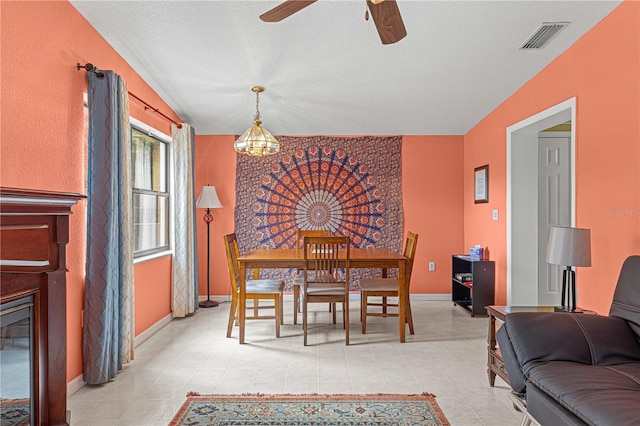 dining room featuring ceiling fan, a textured ceiling, and lofted ceiling