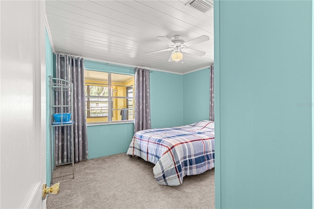 bedroom with ornamental molding, carpet, and ceiling fan