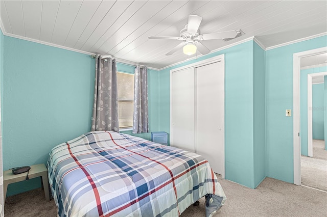 bedroom featuring ornamental molding, light colored carpet, ceiling fan, and a closet