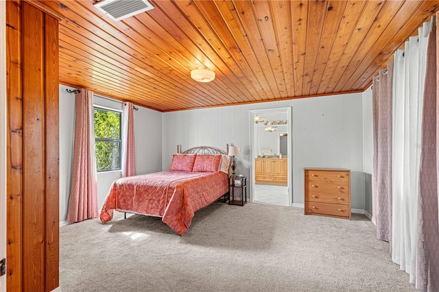 carpeted bedroom featuring wooden ceiling, ensuite bathroom, wood walls, and crown molding