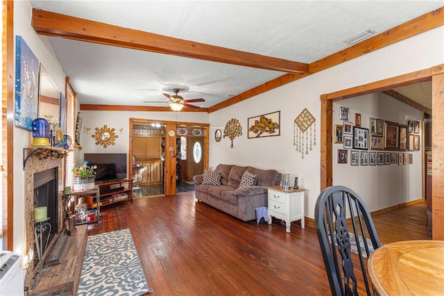 living room with dark hardwood / wood-style flooring, ceiling fan, and beam ceiling