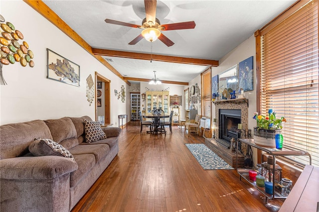 living room featuring lofted ceiling with beams, dark wood-type flooring, and ceiling fan