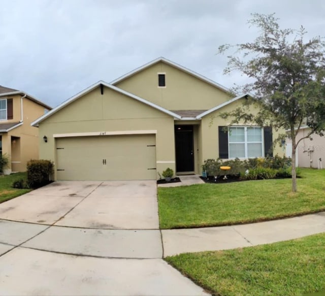 view of front of home with a garage and a front lawn