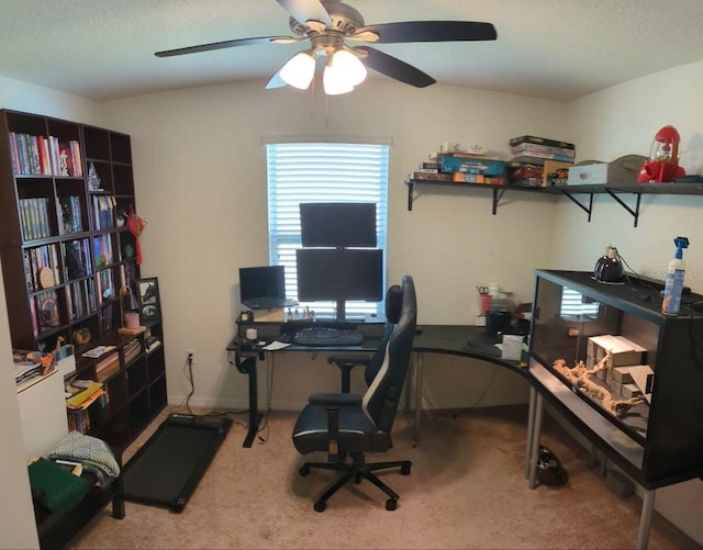 carpeted home office with a textured ceiling and ceiling fan