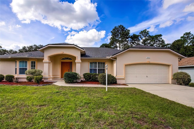 single story home featuring a garage and a front yard