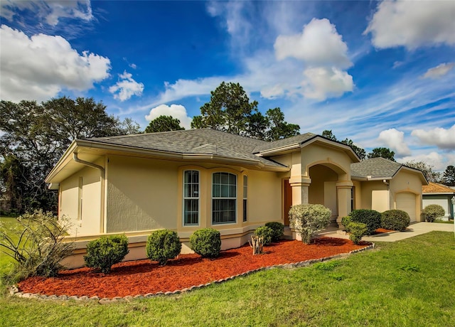 view of front facade with a front lawn and a garage