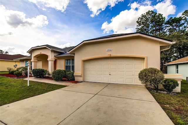 view of front of home featuring a front lawn and a garage