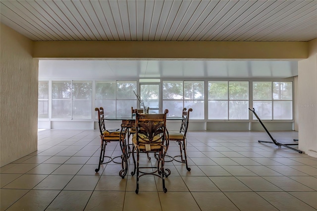 tiled dining room featuring wood ceiling