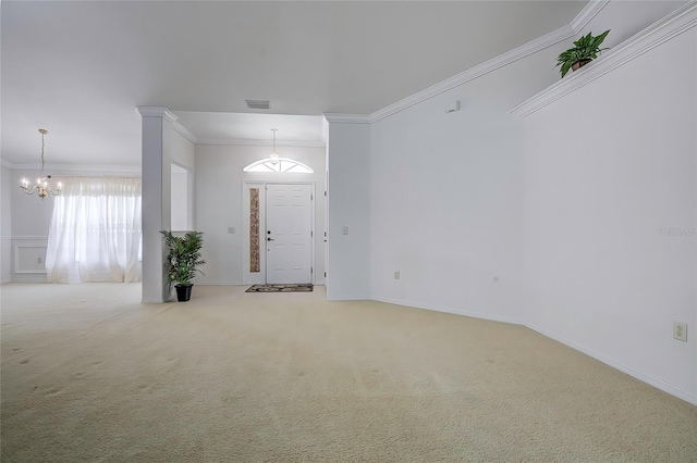 foyer entrance with carpet, an inviting chandelier, and ornamental molding